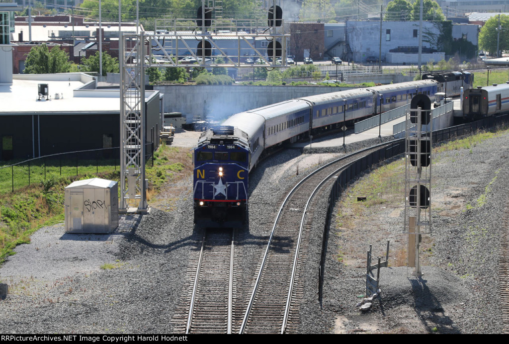 RNCX 1984 leads train P075-22 away from the station